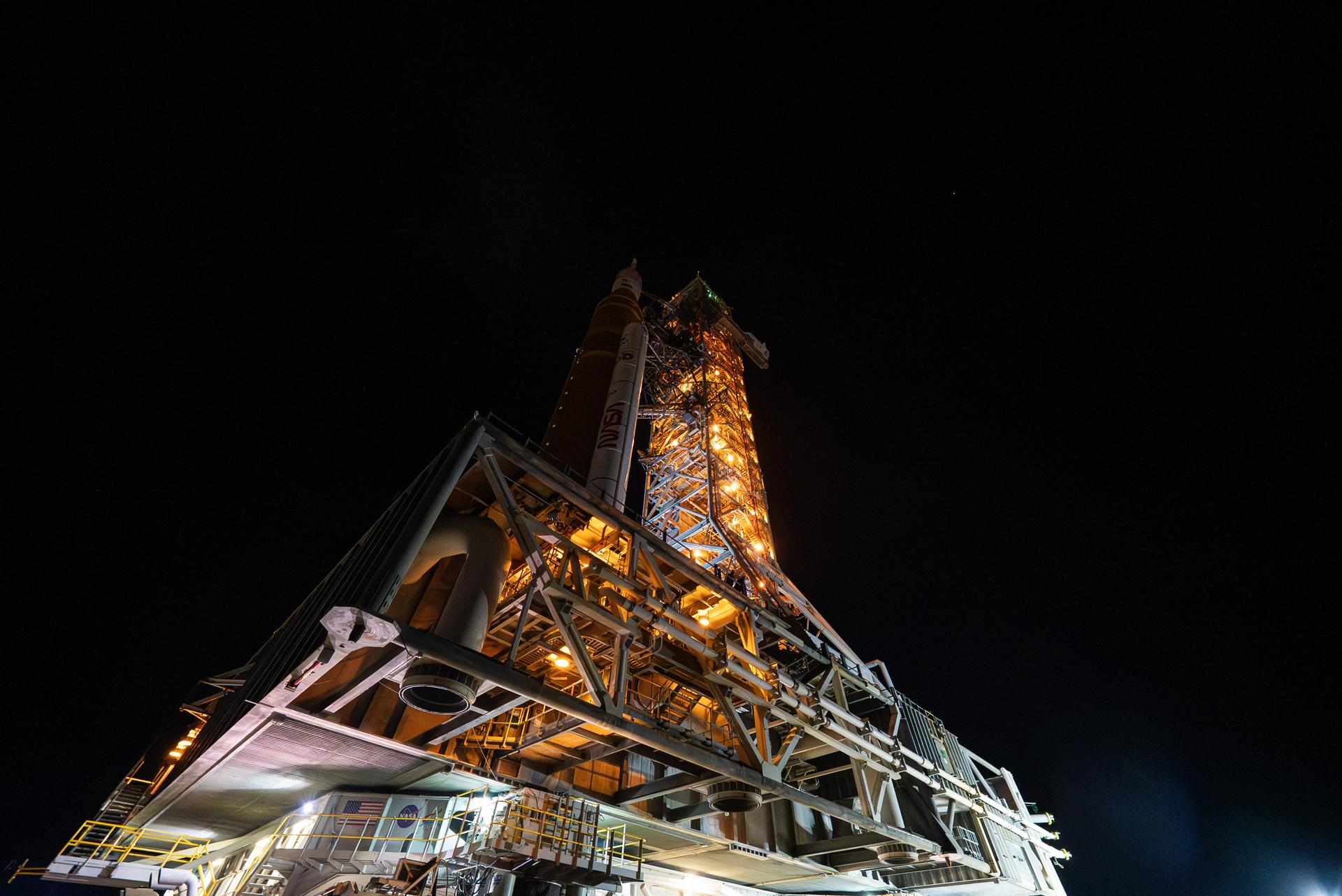 This image shows NASA’s SLS (Space Launch System) and Orion spacecraft rolling out of the Vehicle Assembly Building at NASA’s Kennedy Space Center. NASA's massive Crawler-Transporter, upgraded for the Artemis program, carries the powerful SLS rocket and Orion spacecraft on the Mobile Launcher from the Vehicle Assembly Building to Launch Pad 39B at Kennedy Space Center in preparation for the Artemis II mission.